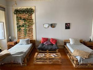 a living room with two beds and a table at Faroway Hostel in Faro