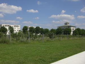 a field of grass with buildings in the background at Appartement luxueux et cosy in Cergy