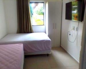 a small bedroom with a bed and a window at Casa em Condomínio Fechado com Sauna e Piscina in Salinópolis +37 photos