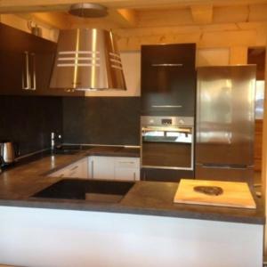 a kitchen with stainless steel appliances and a stove at Les Etoiles de Vonnes 2 in Châtel