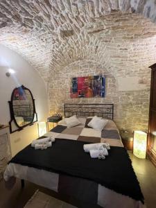 a bedroom with a large bed with towels on it at Residenza Le Tre Volte - colazione inclusa con TicketBar in Martina Franca