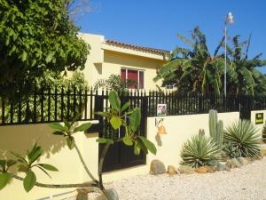 a fence in front of a house with plants at Alta Montaña in Noord