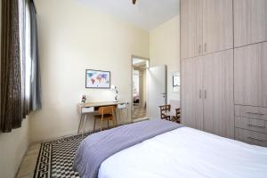 a bedroom with a bed and a desk in it at Casa Vecchia 1930’s Central Masterpiece in Kos Town