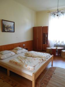a bedroom with a large bed in a room at ENZO Apartman Gyula in Gyula