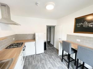a kitchen with a counter top and a table at 53 Church Street in Warrington
