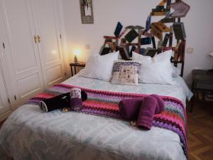 a bed with a colorful blanket and pillows on it at Warm and well connected in Madrid