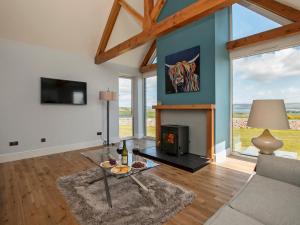 a living room with a couch and a fireplace at Quarter Acre House in Challoch