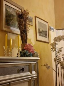 a room with a dresser with candles and flowers on it at B&B Baldovino di Monte in Monte San Savino