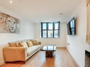 a living room with a couch and a table at Queens Bridge Apartment in Ramsgate