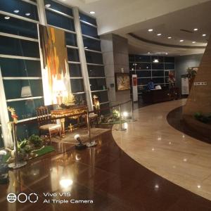 a lobby with a table and chairs in a building at MANILA BAY EXECUTIVE SUITE pearl of orient in Manila