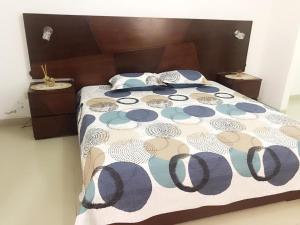 a bed with a blue and white comforter and pillows at Casa en condominio el dorado in Trinidad