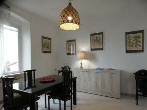 a dining room with a table and a chandelier at CA' ARGENTINA Appartamento Vista MARE in La Spezia