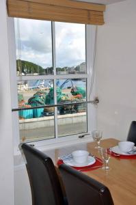 a dining room table with a view of the ocean at Castle View Stornoway in Stornoway