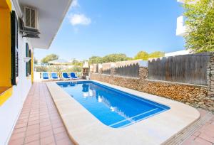 a swimming pool in the backyard of a house at Villa Asarel by Sonne Villas in Cala Galdana