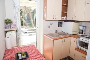 a small kitchen with a sink and a counter top at Sunny and Quiet 1 Bedroom Apt in Athens