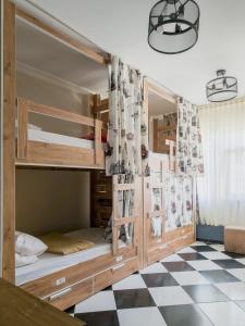 a bedroom with bunk beds with a checkered floor at Taksim Hostel Green House Istanbul in Istanbul