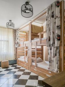 a bunk bed in a room with a checkered floor at Taksim Hostel Green House Istanbul in Istanbul