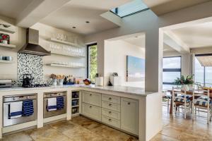 a kitchen with a large counter and a dining room at Ocean's Horizon Beach House in Scarborough