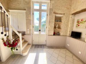 a room with a staircase and a door with a window at La Montgrande, 2 bed gîte, Aulnay in Aulnay