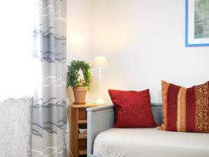 a bedroom with a bed with red pillows at Wolke 7 in Görwihl