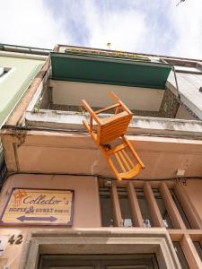 a chair sitting on the side of a building at Collector's Home in Braga