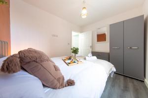 a bedroom with a white bed with a tray on it at Cosy 1 bed in Stockport centre in Stockport