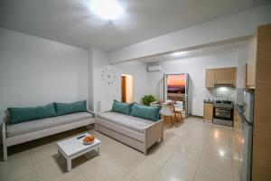 a living room with a couch and a table at A & G Apartments in Kolymvari