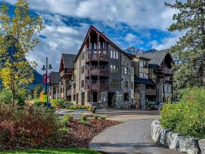 a large building on a street in the mountains at Spring Creek Condo by Canadian Rockies Vacation Rentals in Canmore