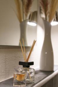 a table with a bowl of oil and a vase at Casa Benedicta in Trier