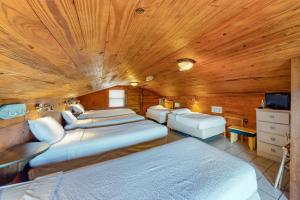 1 dormitorio con 4 camas y techo de madera en O'Grady's Full Sunset, en Panama City Beach