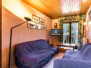a bedroom with a bed and a lamp and a window at Appartement La Clusaz, 3 pièces, 5 personnes - FR-1-437-28 in La Clusaz