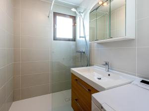 a white bathroom with a sink and a mirror at Appartement La Clusaz, 2 pièces, 4 personnes - FR-1-437-83 in La Clusaz