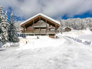 a house covered in snow with a snow covered driveway at Appartement La Clusaz, 2 pièces, 4 personnes - FR-1-437-83 in La Clusaz
