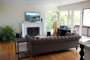 a living room with a couch and a fireplace at North Berkeley Home in Berkeley