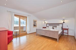 sala de estar con cama y sofá rojo en Chalet Chiemgau en Reit im Winkl