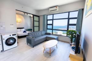 a living room with a couch and a bed at HayBay Jesselton Quay Deluxe Seaview Suite 海景观 in Kota Kinabalu +183 photos