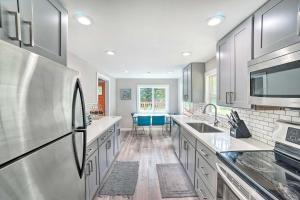 a kitchen with stainless steel appliances and a sink at Modern Gold Bar Vacation Rental with Mountain View in Gold Bar +17 photos