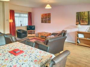 a living room with a table and chairs and a television at Primrose - W43303 in Goxhill