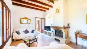 a living room with a fireplace and a couch at Cala mezquida - 42214 Mallorca in Capdepera