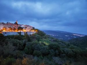 a town on top of a hill at night at The View in Labin