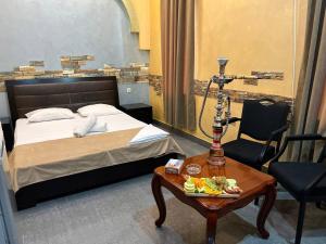 a hotel room with a bed and a table with a table at JOY Hotel in Yerevan