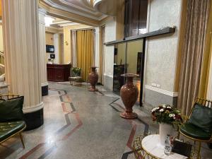 a lobby with vases on the wall and a table at JOY Hotel in Yerevan