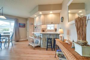 a kitchen and living room with a counter and a table at Walk to Beach North Myrtle Condo! in Myrtle Beach