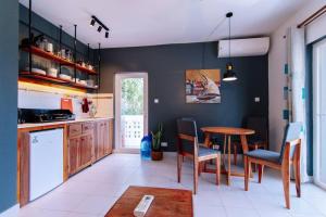 a kitchen with a table and chairs and a table at Amani Cottage in Dambani