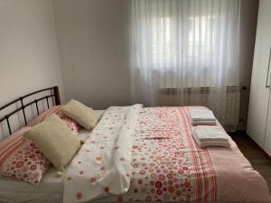 a bed with a blanket and pillows on it at House Delboy with garage, Črnomerec in Zagreb