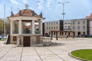 a gazebo in the middle of a parking lot at Coreto Garden in Vila do Conde +15 photos