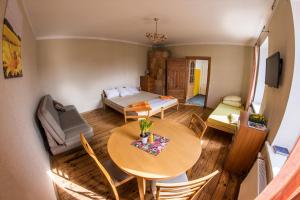 a small living room with a table and a bed at Medainie apartamenti in Liepāja
