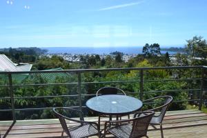 a patio with a table and chairs on a balcony at Cabañas Krause Lodge in Puerto Varas