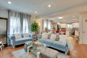 a living room with blue couches and a table at Chic Baltimore Retreat - 6 Mi to Downtown! in Baltimore