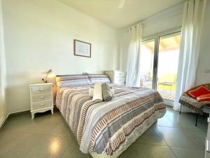a bedroom with a large bed and a window at El Ático Estepona 1ªLinea de Playa in Estepona